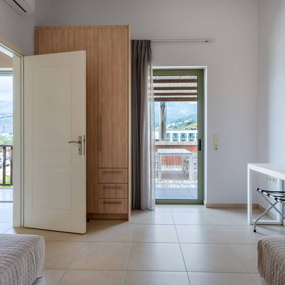 bedroom with two single beds and balcony in a three bedrooms villa with sea view in plakias, rethymno, crete