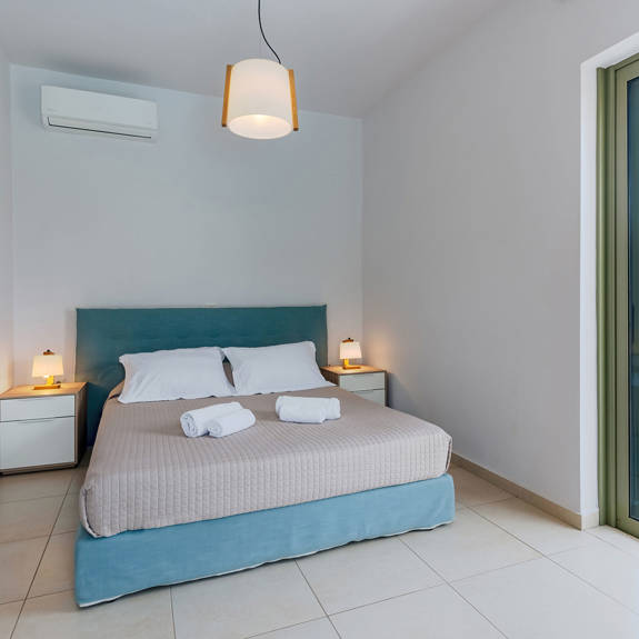 modern double bed bedroom with garden view in a three bedrooms villa with sea view in plakias, rethymno, crete