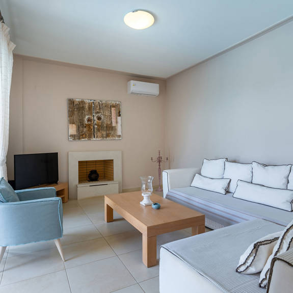 big living room with fireplace in a three bedrooms villa with sea view in plakias, rethymno, crete