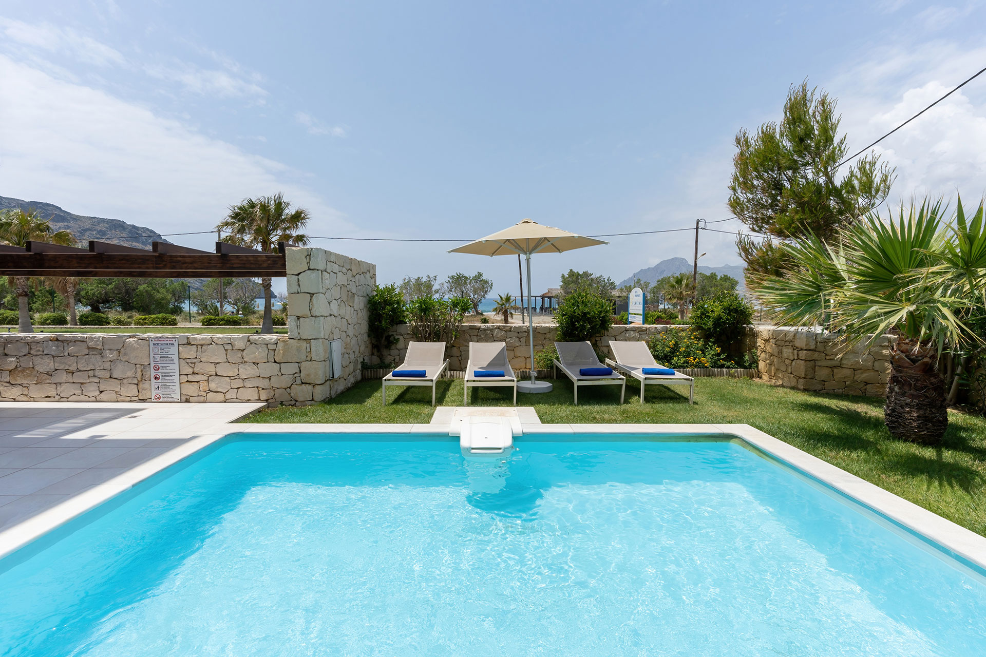 swimming pool with sunbeds and garden in a three bedrooms villa with pool and sea view in plakias, rethymno, crete