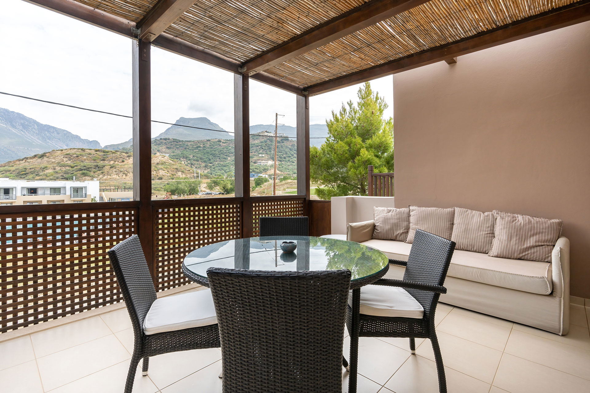 big terrace with couch and table with chairs in a two bedrooms superior apartment in plakias, rethymno, crete