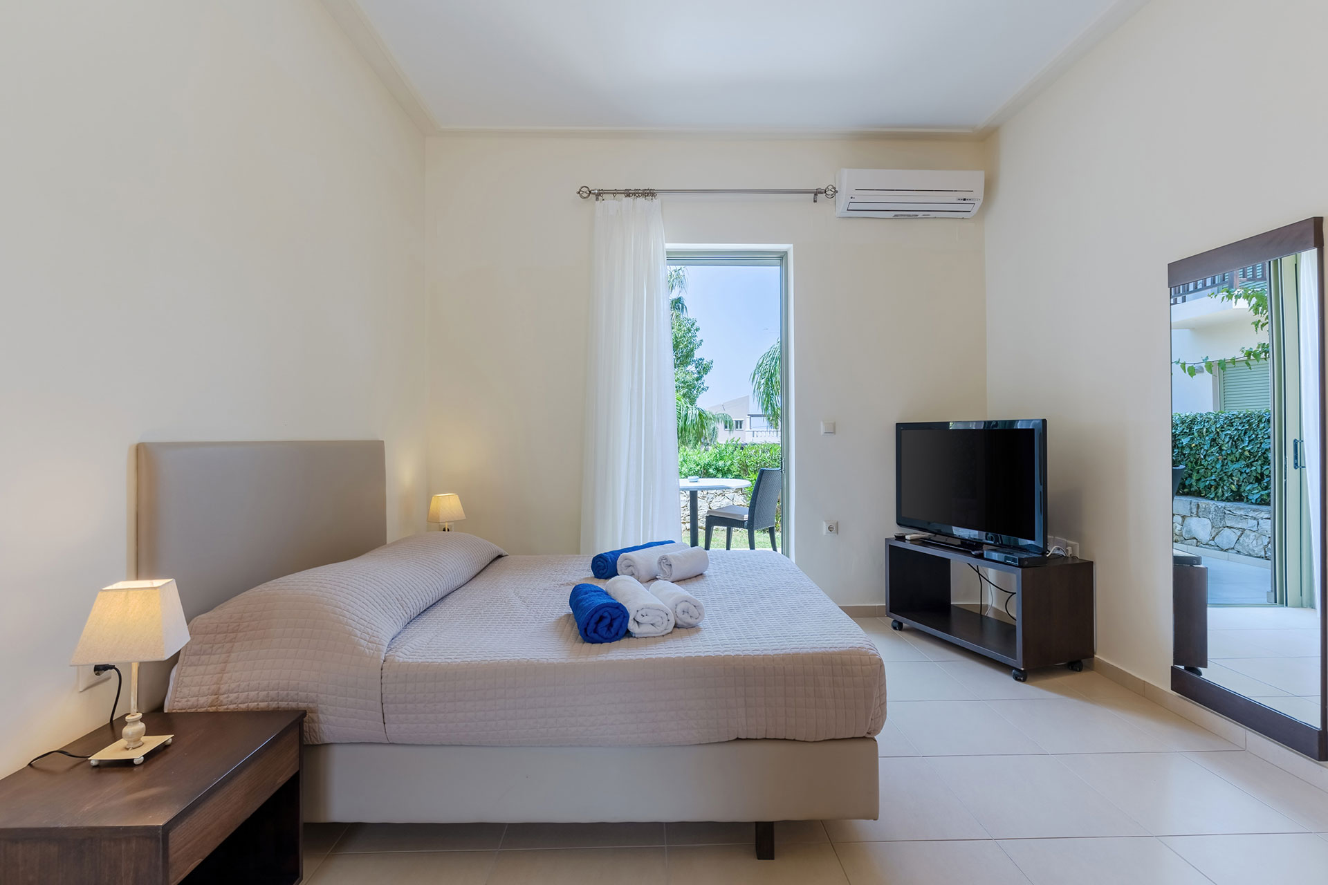 bedroom with air-condition, tv and terrace in a studio in plakias, rethymno, crete