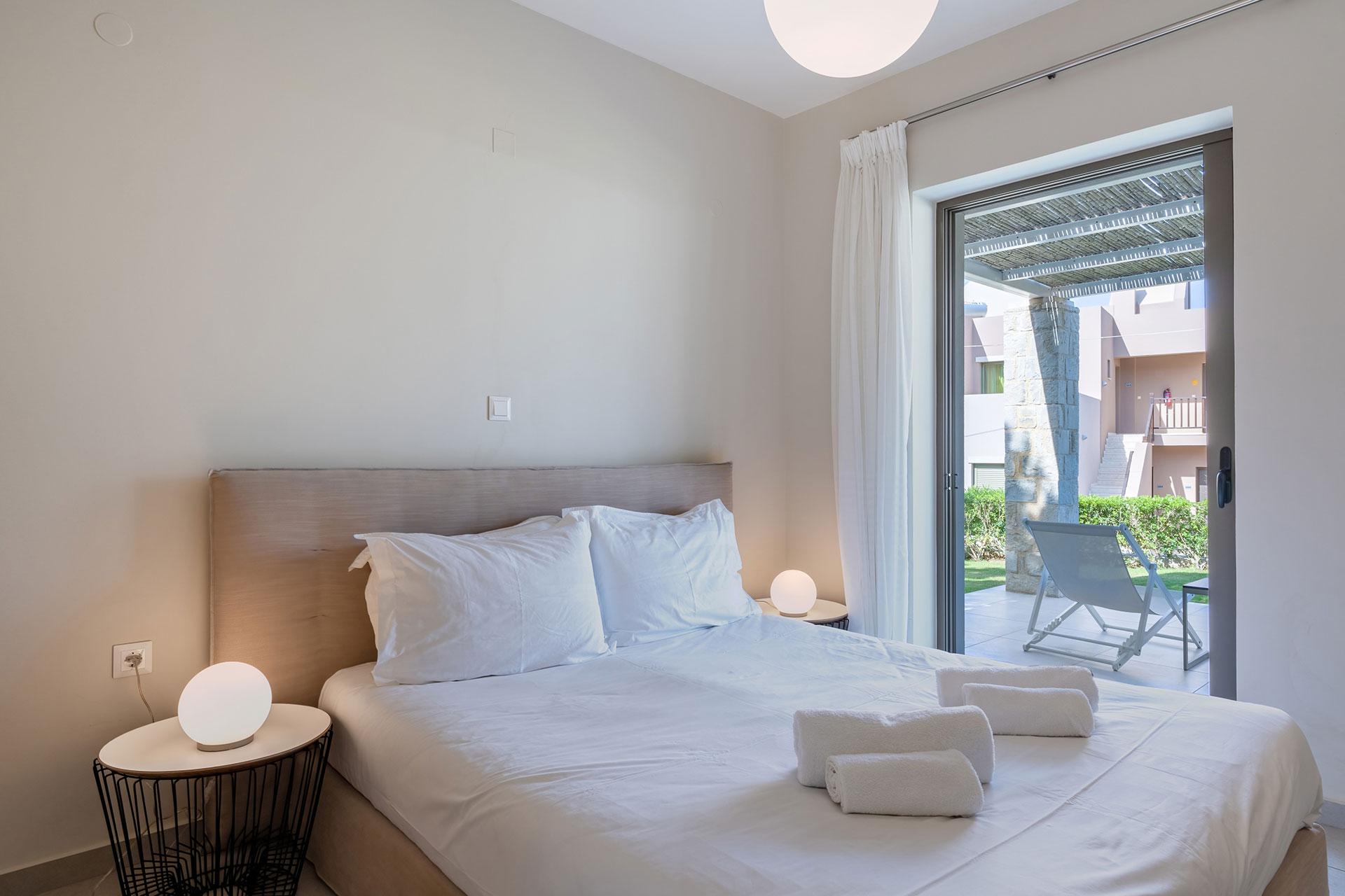 bedroom with double bed and garden view in an one bedroom apartment in plakias, rethymno, crete