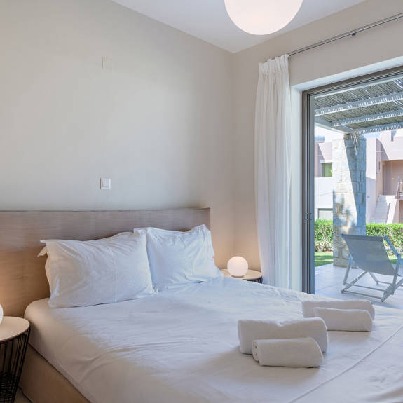 bedroom with double bed and garden view in an one bedroom apartment in plakias, rethymno, crete