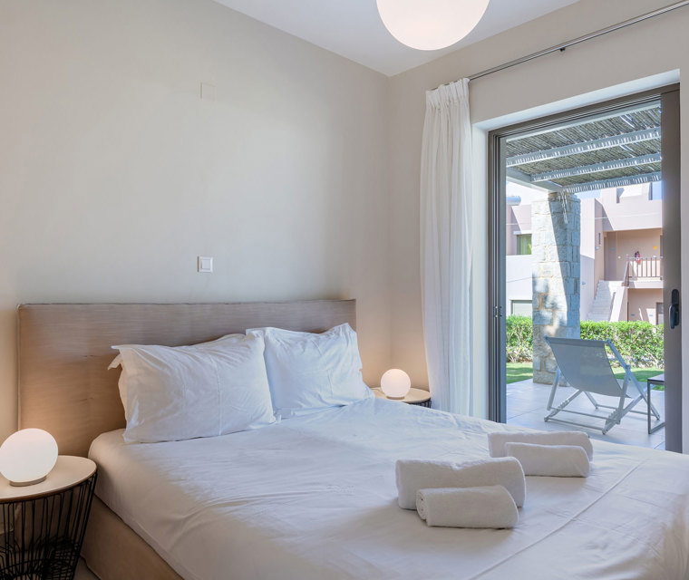 bedroom with double bed and garden view in an one bedroom apartment in plakias, rethymno, crete