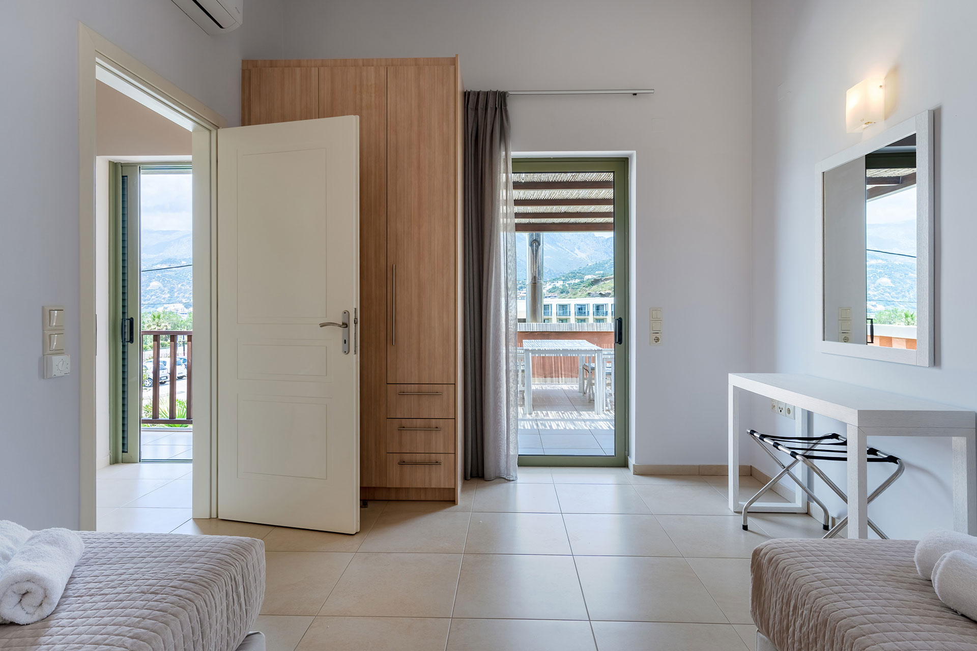bedroom with two single beds and balcony in a three bedrooms villa with sea view in plakias, rethymno, crete