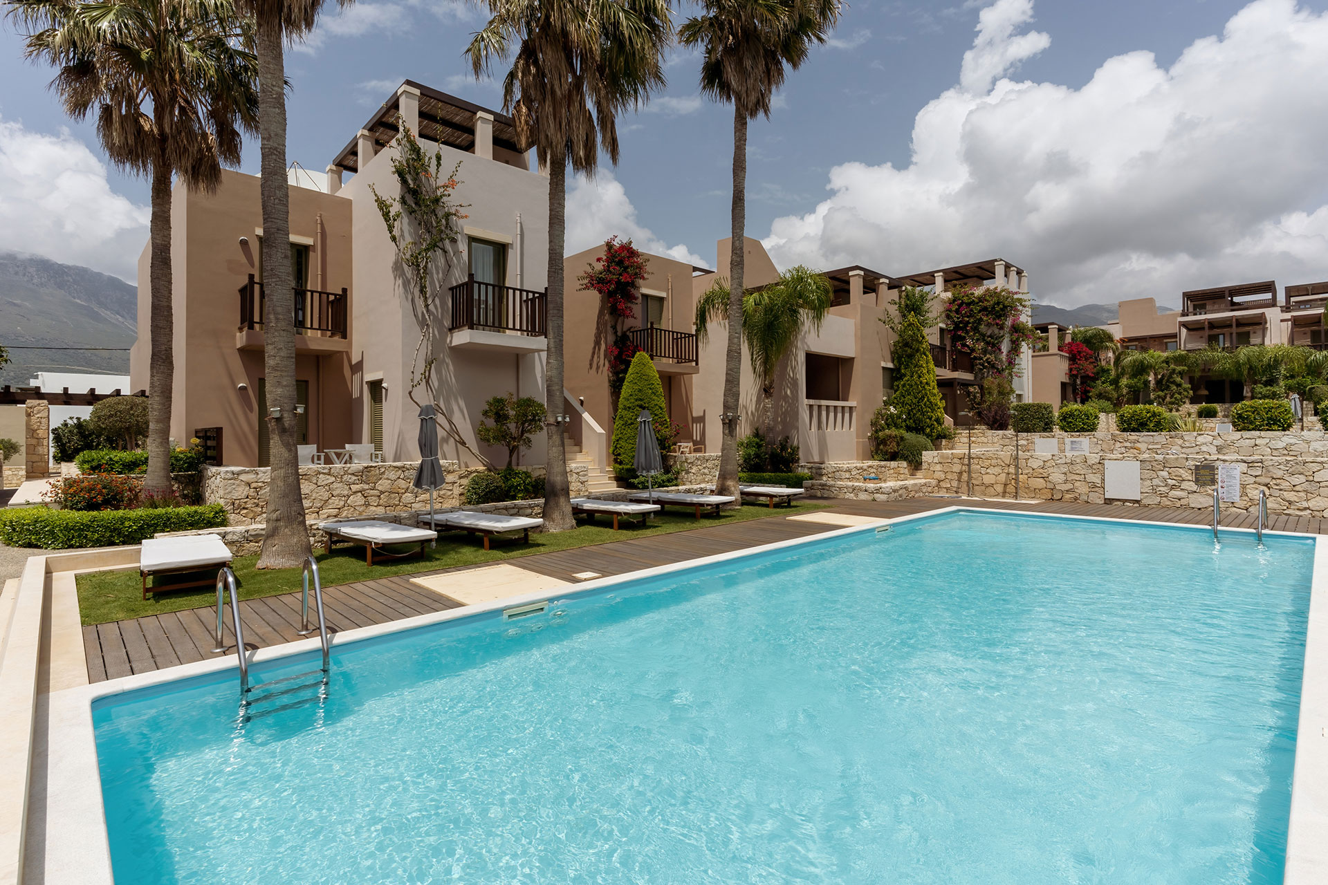 swimming pool with sunbeds and garden in plakias resorts in rethymno crete