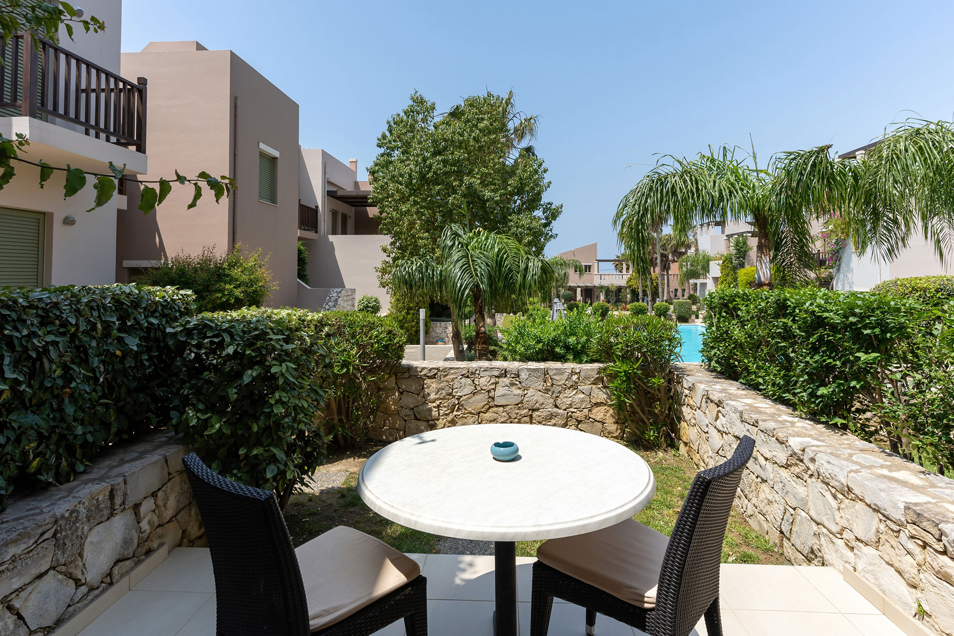 terrace with pool view and lawn in a studio in plakias, rethymno, crete