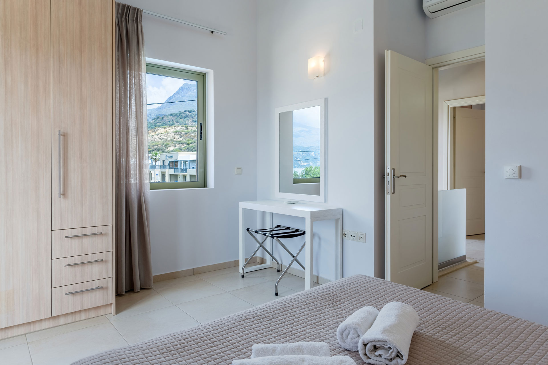 bedroom with closet and mirror in a three bedrooms villa with sea view in plakias, rethymno, crete