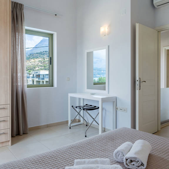 bedroom with closet and mirror in a three bedrooms villa with sea view in plakias, rethymno, crete