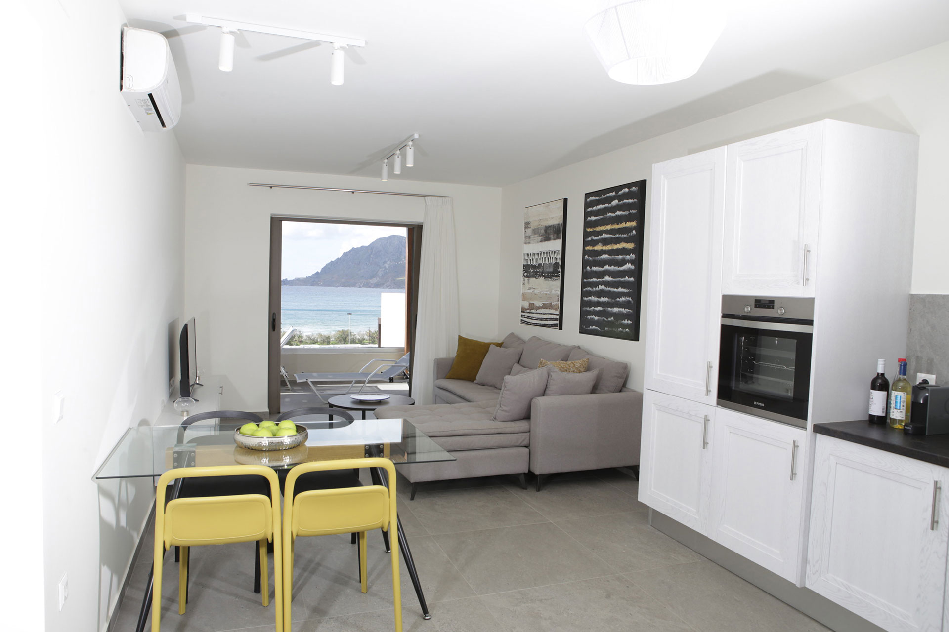 kitchen area and modern living room with sea view in a two bedrooms superior apartment in plakias, rethymno, crete