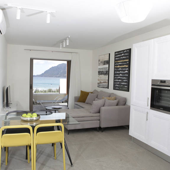kitchen area and modern living room with sea view in a two bedrooms superior apartment in plakias, rethymno, crete