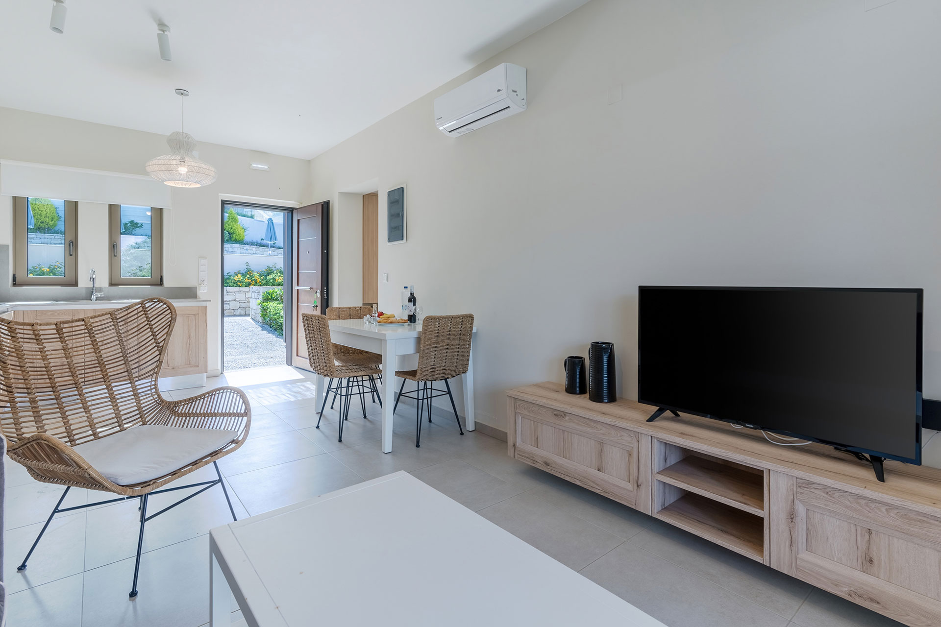 apartment with living room, tv and kitchen table in an one bedroom apartment in plakias, rethymno, crete