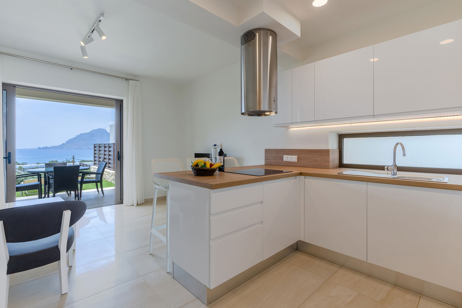 modern kitchen next to living room, and terrace with sea view in a two bedrooms maisonette in plakias, rethymno, crete