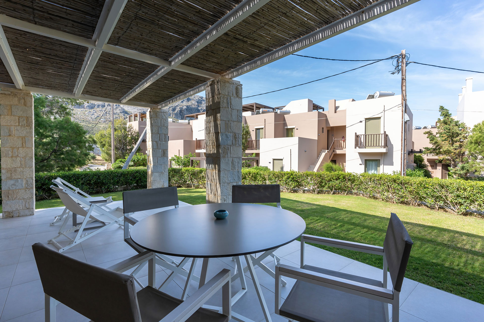 terrace in the garden with table and chairs in an one bedroom apartment in plakias, rethymno, crete