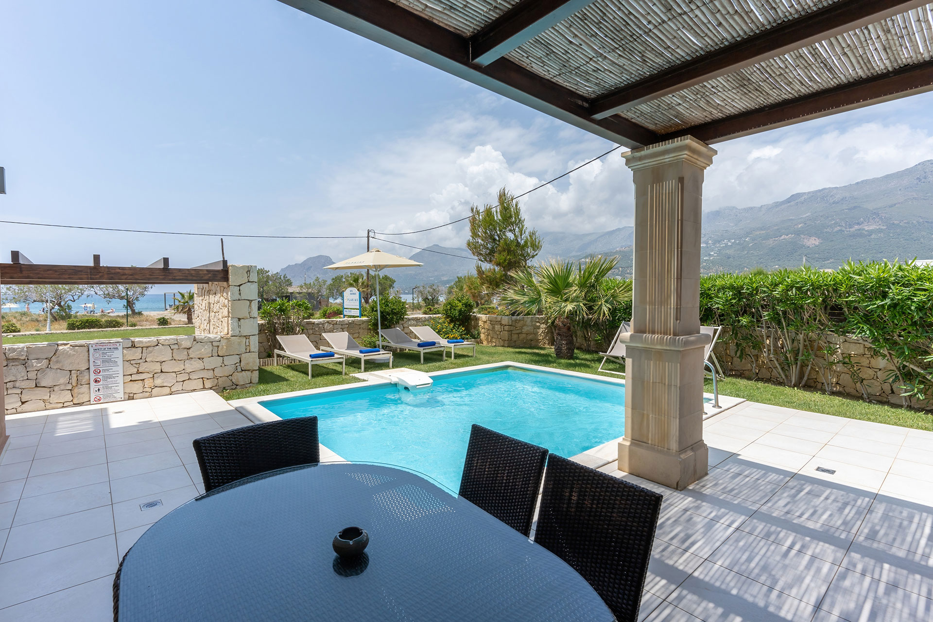 garden with cane canopy and swimming pool in a three bedrooms villa with pool and sea view in plakias, rethymno, crete