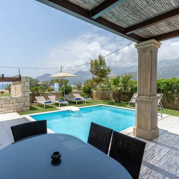 garden with cane canopy and swimming pool in a three bedrooms villa with pool and sea view in plakias, rethymno, crete