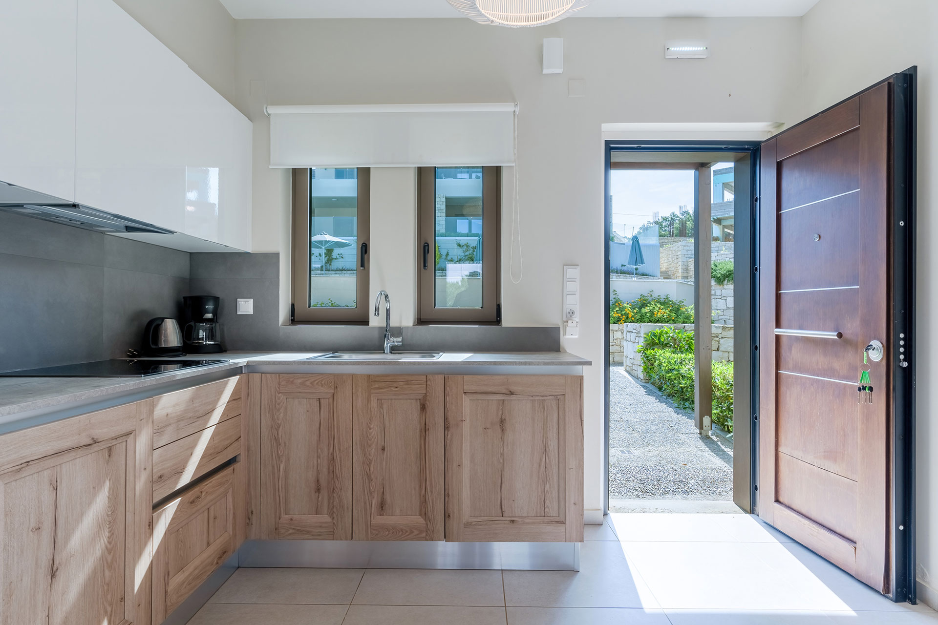 kitchen with espresso machine and garden view in an one bedroom apartment in plakias, rethymno, crete
