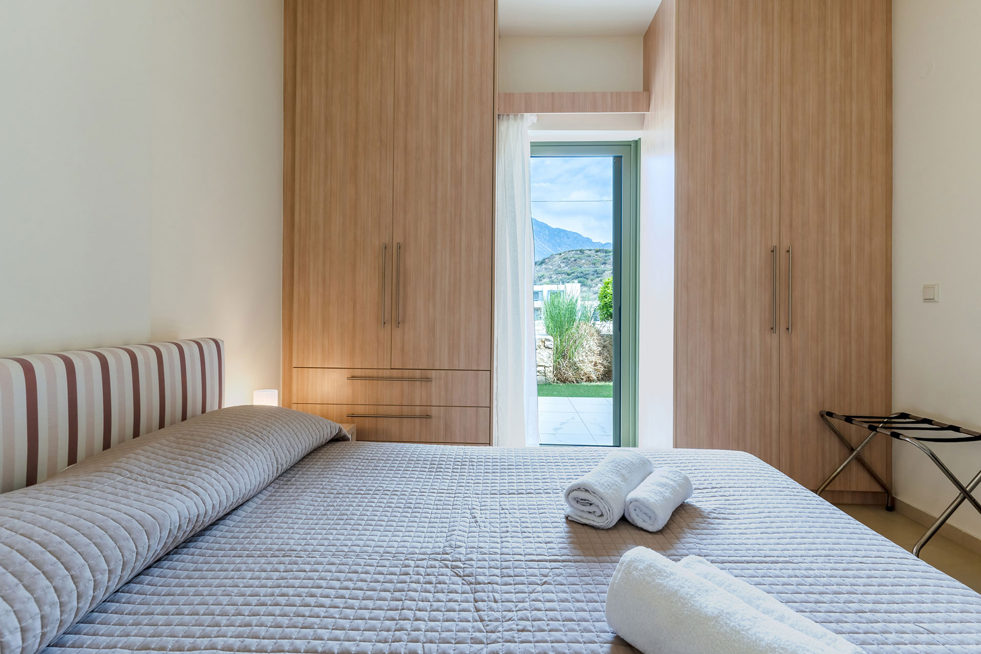 bedroom with double bed, closets and garden view in a two bedrooms apartment in plakias, rethymno, crete