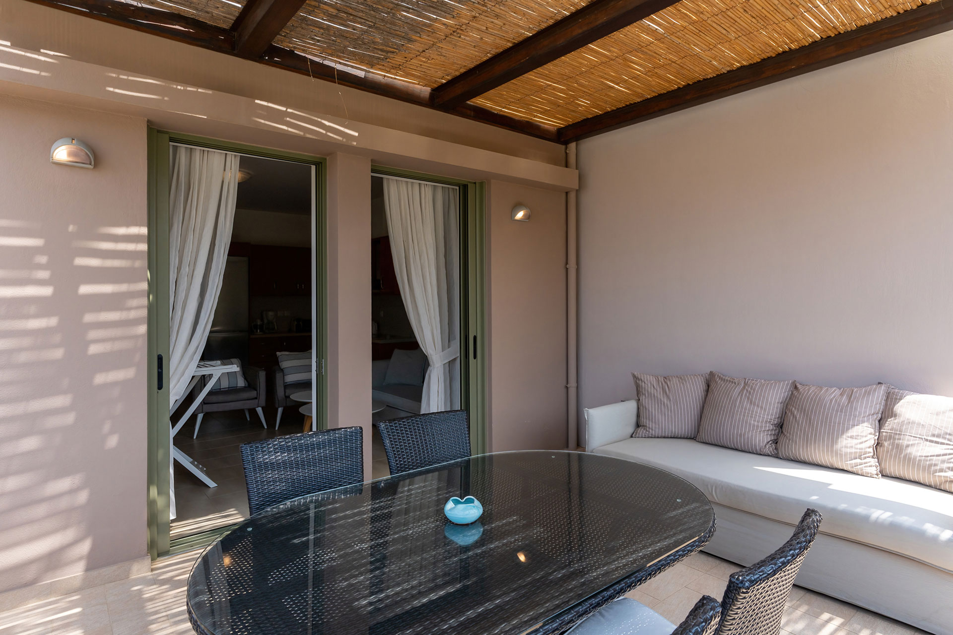 terrace with cane canopy and couch in a two bedrooms apartment in plakias, rethymno, crete