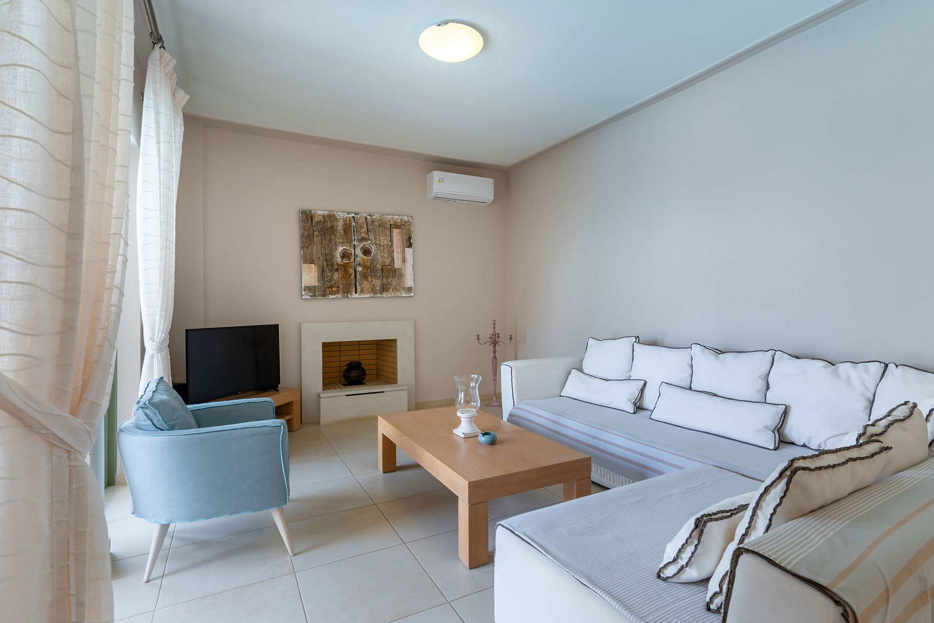 big living room with fireplace in a three bedrooms villa with sea view in plakias, rethymno, crete