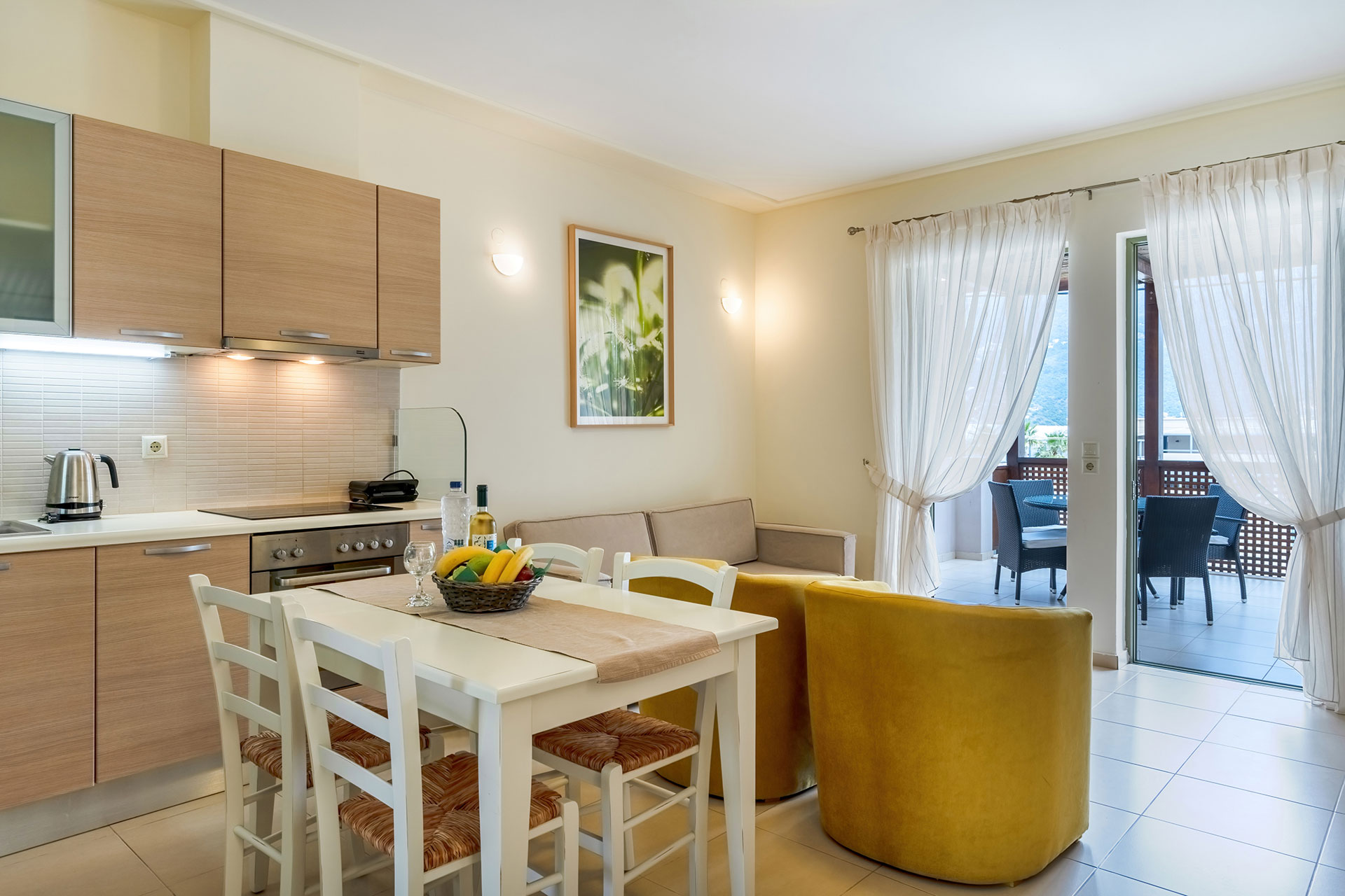 kitchen table with chairs, and living room in a two bedrooms apartment in plakias, rethymno, crete