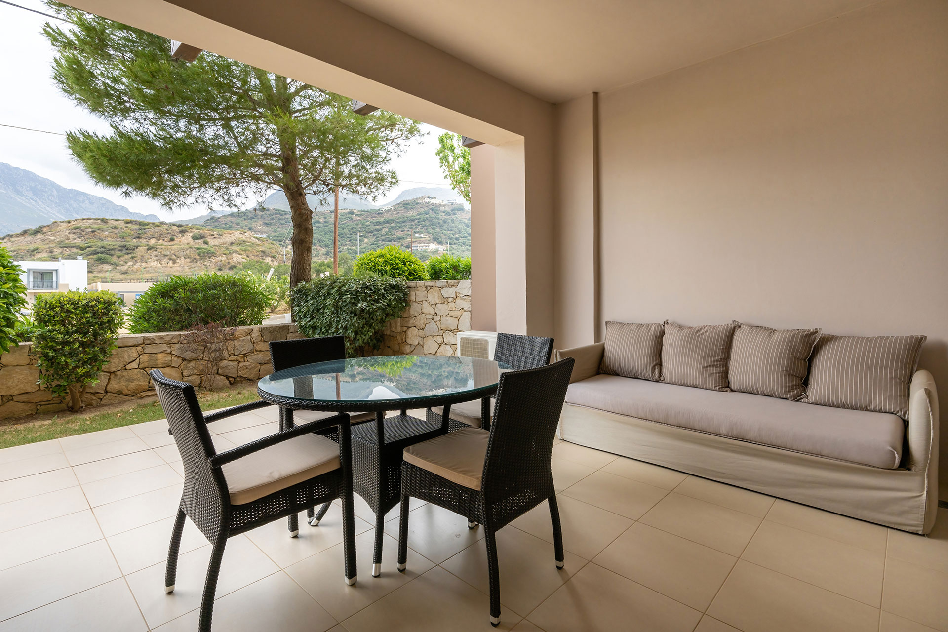 balcony with big couch and table with chairs in a two bedrooms apartment in plakias, rethymno, crete