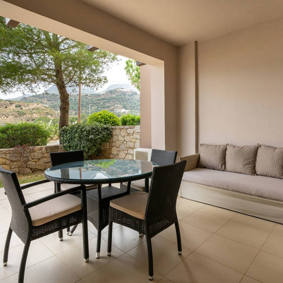 balcony with big couch and table with chairs in a two bedrooms apartment in plakias, rethymno, crete