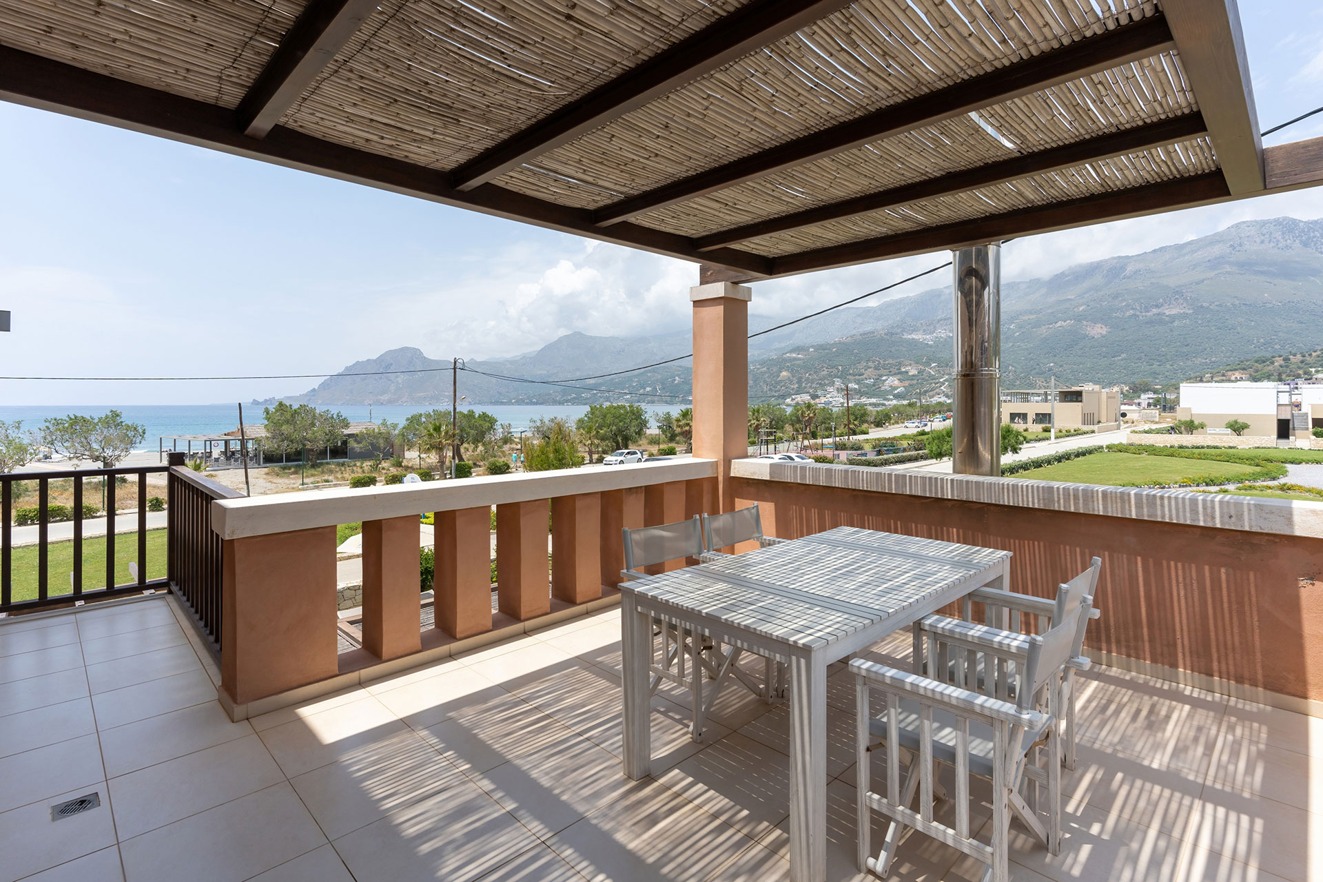 big terrace with white furniture and cane canopy in a three bedrooms villa with sea view in plakias, rethymno, crete