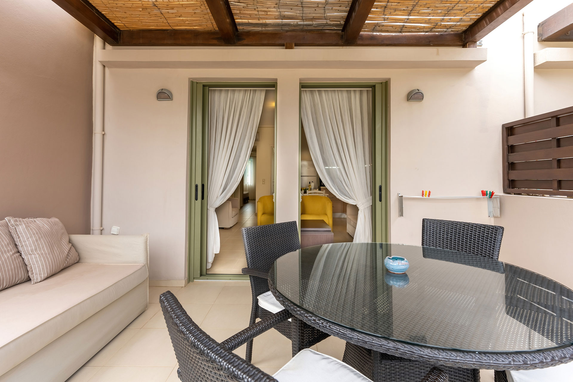 cozy terrace with couch and table with chairs in a two bedrooms superior apartment in plakias, rethymno, crete