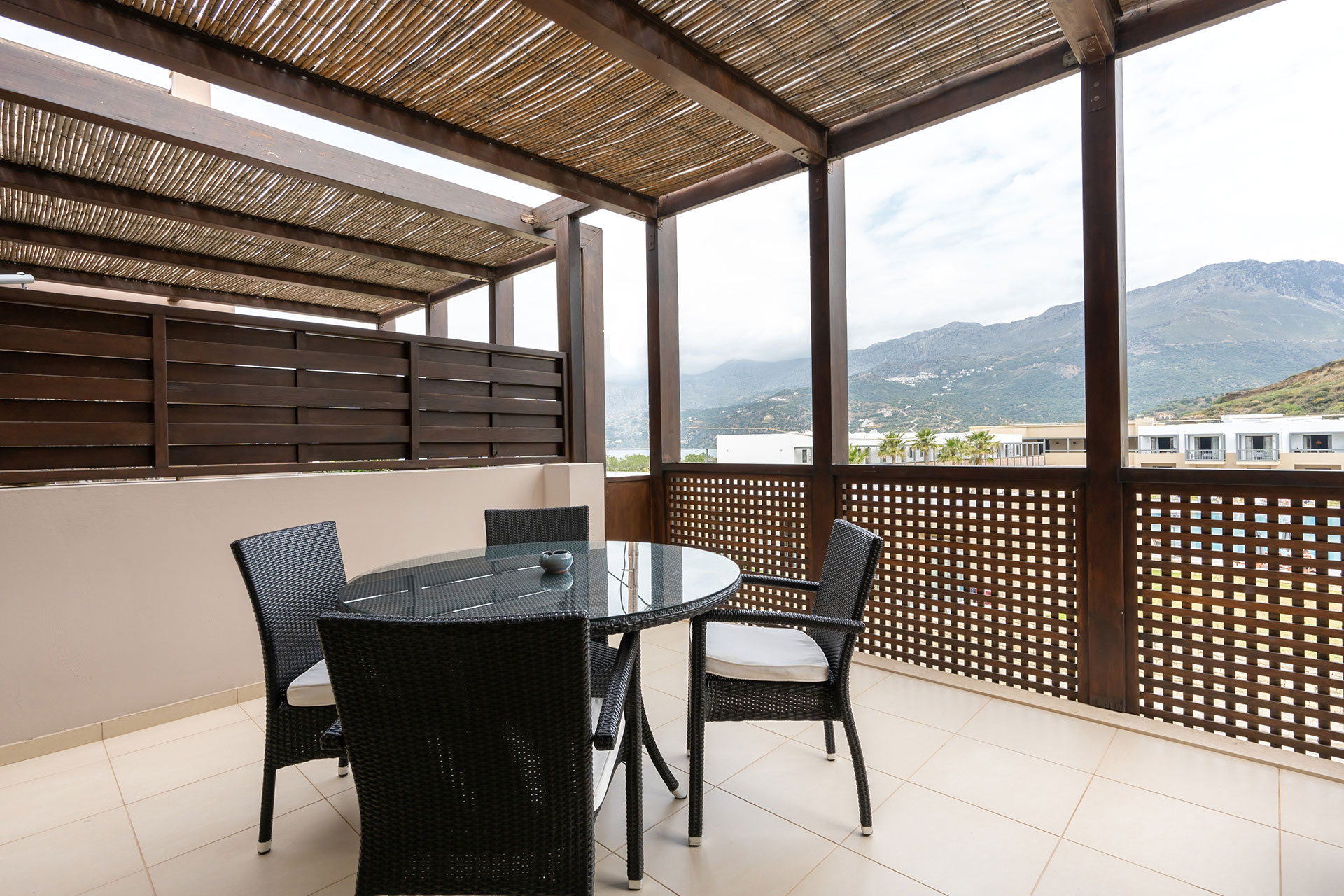 big terrace with table and chairs in a two bedrooms superior apartment in plakias, rethymno, crete