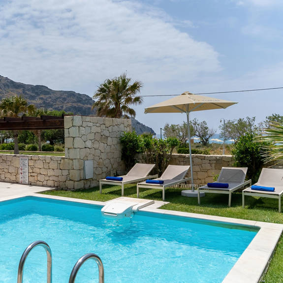 swimming pool with sunbeds in a three bedrooms villa with pool and sea view in plakias, rethymno, crete